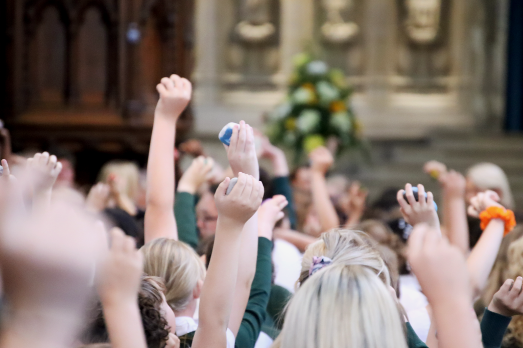 year 6 leavers celebration at rochester cathedral with aletheia academies trust holding the 'stepping stones' in the air